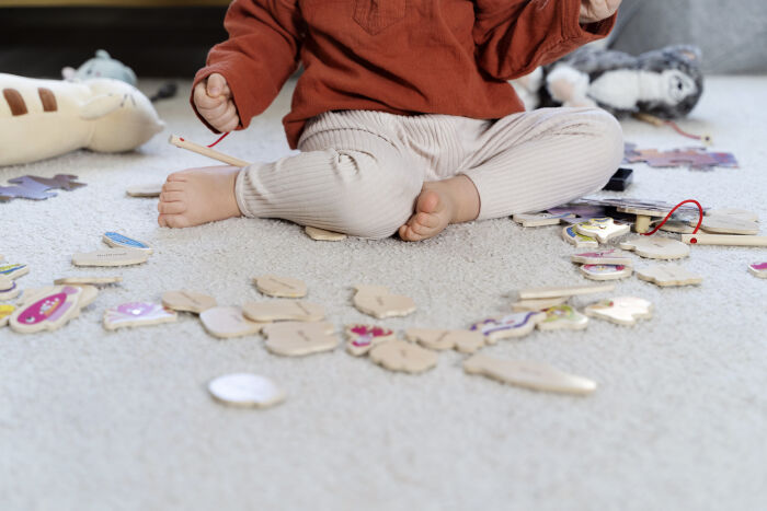 close-up-kid-with-wooden-toys-floor.jpg