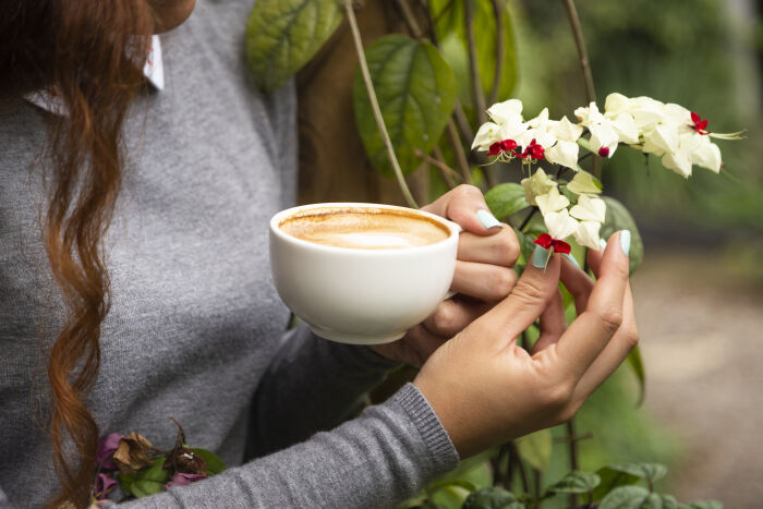 close-up-woman-holding-coffee-cup.jpg